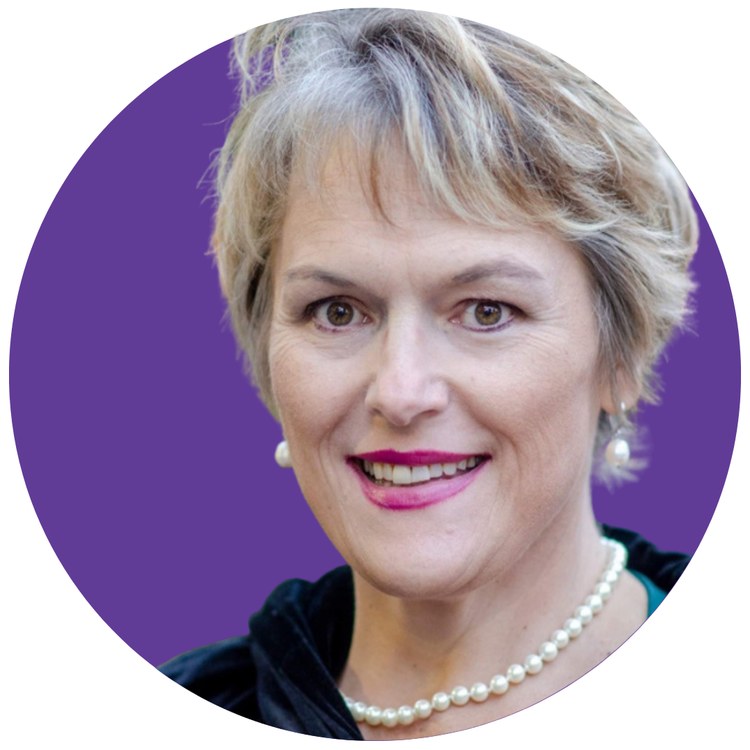 Amy Scott-Slovick smiling, in a purple circle portrait