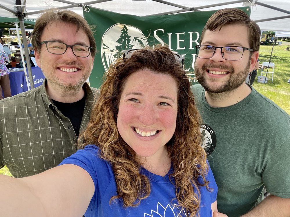 Rebecca takes a selfie with volunteers at a Sierra Club community booth